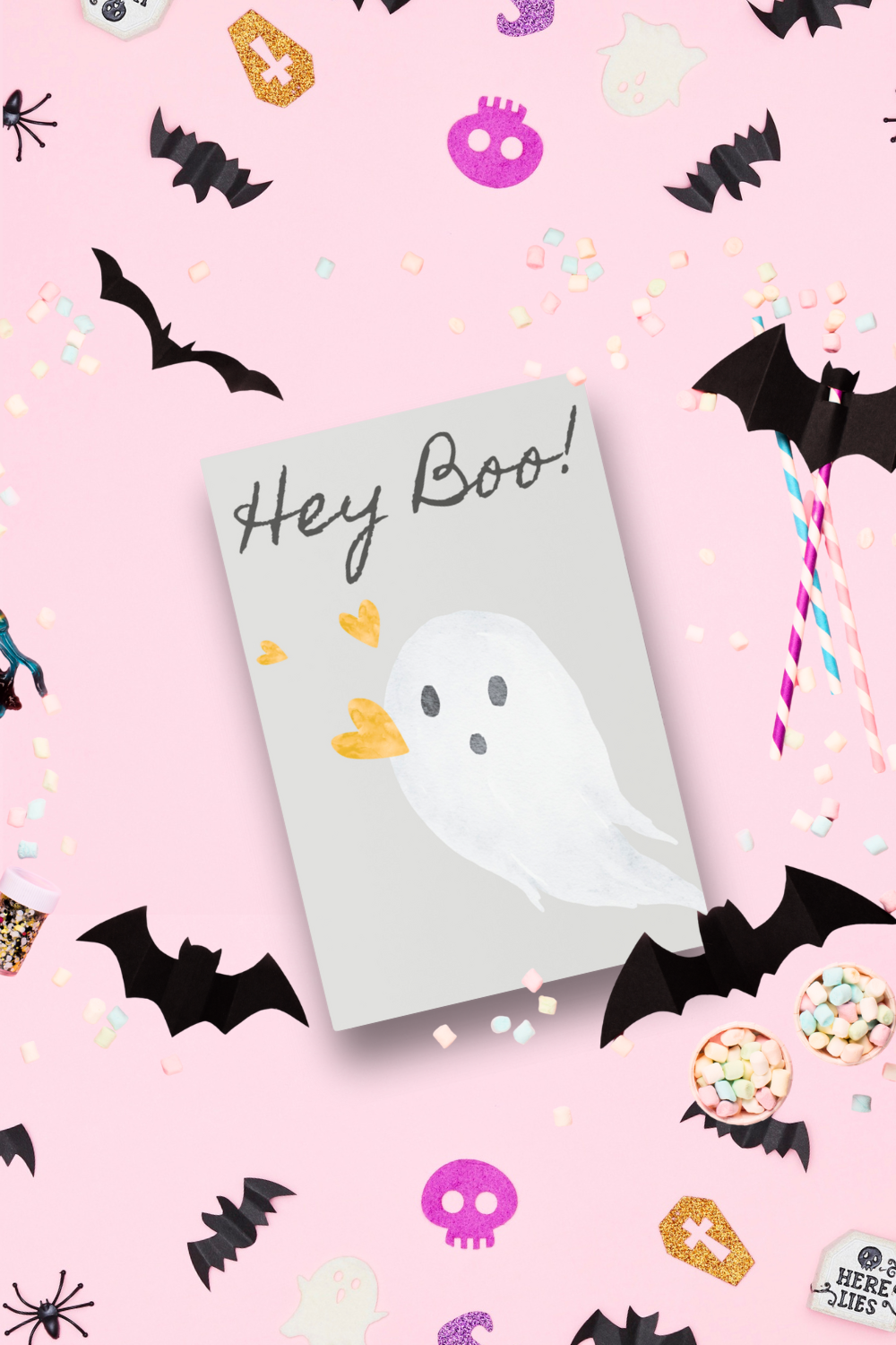 Halloween-themed notepad with ghost design and 'Hey Boo!' text on a pink background with Halloween decorations.