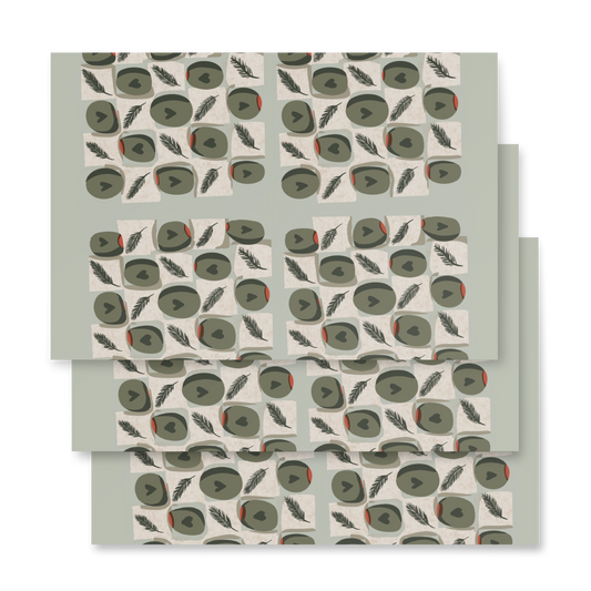 Three sheets of premium matte wrapping paper featuring a repeating pattern of green olives, and cheese blocks on a green background, designed by Wishbrush.