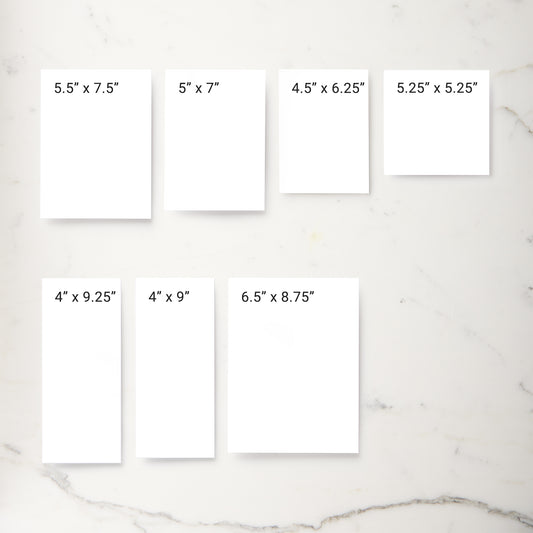 Six white rectangular print mockups arranged on a light marble surface, each labeled with different print dimensions such as 5.5" x 7.