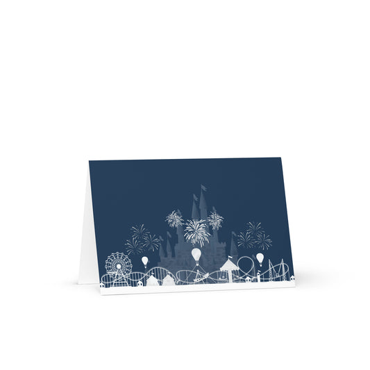 Navy blue card with white illustrations of a Ferris wheel, roller coaster, and fireworks on a white background