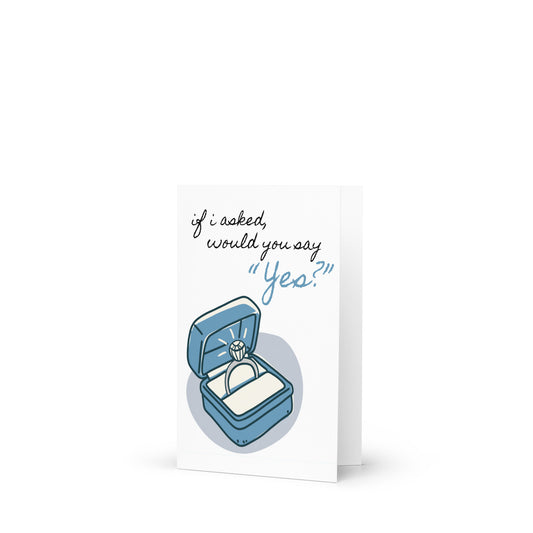 Greeting card with a blue ring box and text 'if i asked, would you say 'Yes?'' on a white background