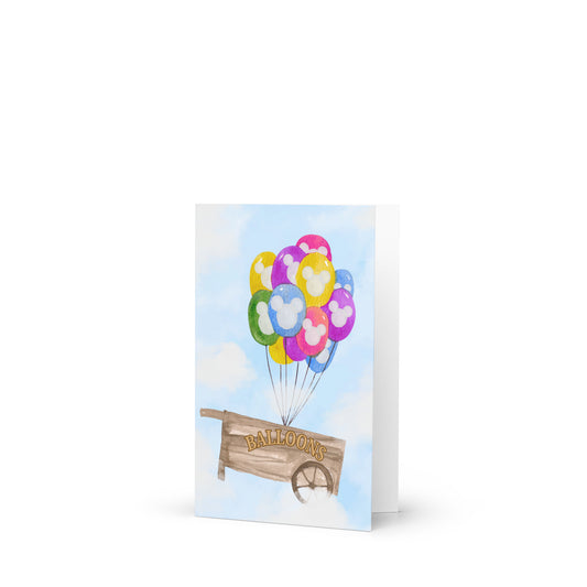 Greeting card with colorful balloons and a wooden sign on a white background