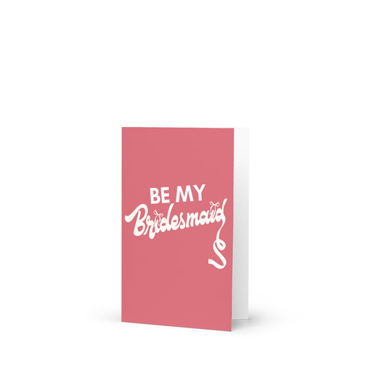 Pink card with 'Be My Bridesmaid' text on a white background