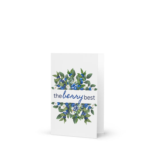 Greeting card with blueberries and green leaves design on a white background