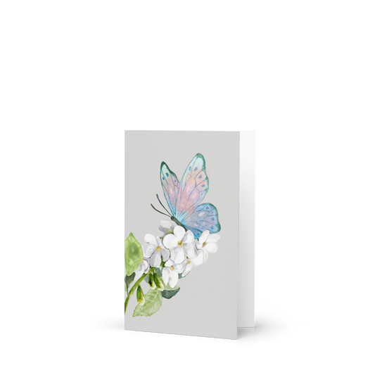 Greeting card with a butterfly and flowers on a white background