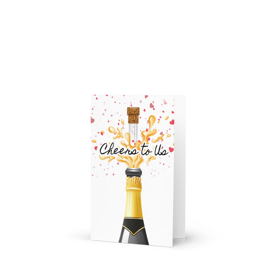 Greeting card with a champagne bottle design and 'Cheers to Us' text on a white background