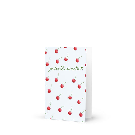 Greeting card with cherry pattern and text 'you're the sweetest' on a white background