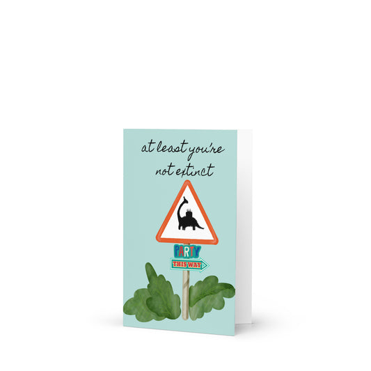Card with a humorous design of a road sign and plants on a light blue background