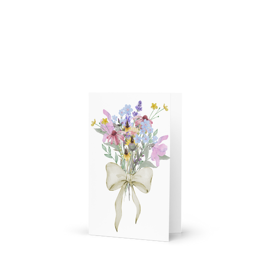 Greeting card with a bouquet of flowers and a bow on a white background
