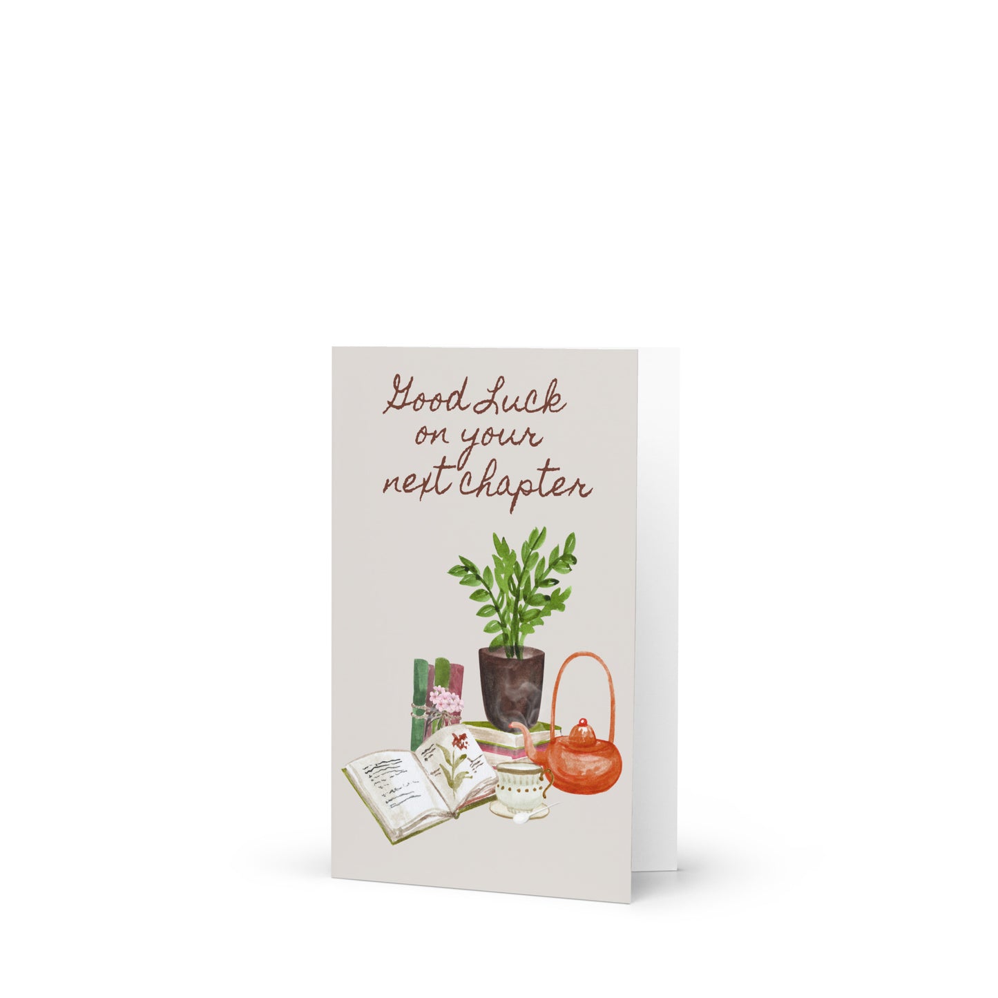 Greeting card with 'Good Luck on your next chapter' text, plants, and a teapot on a white background