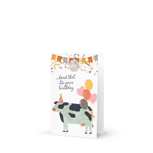 Birthday card with a cow illustration and colorful balloons on a white background