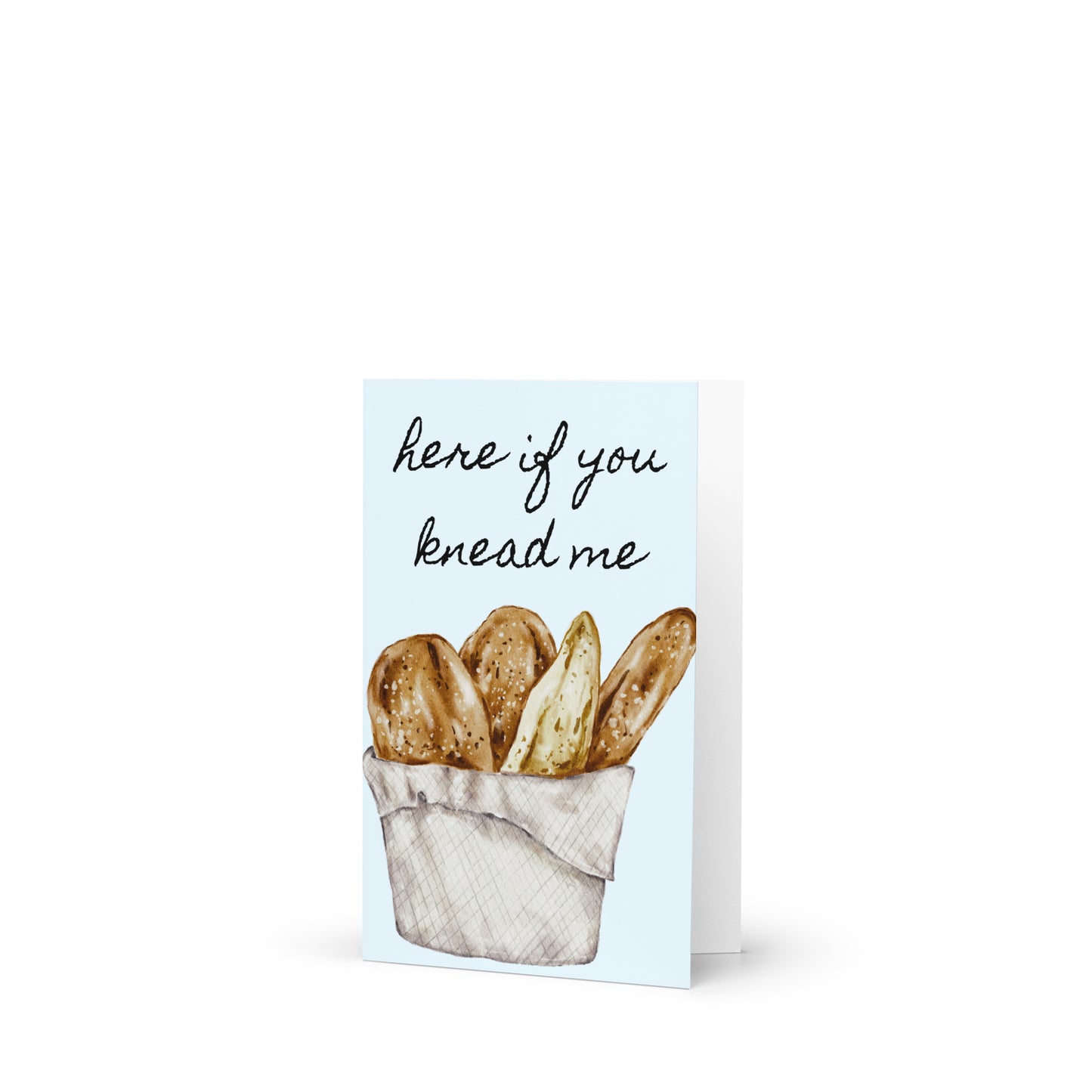 Greeting card with bread illustration and text 'here if you knead me' on a white background