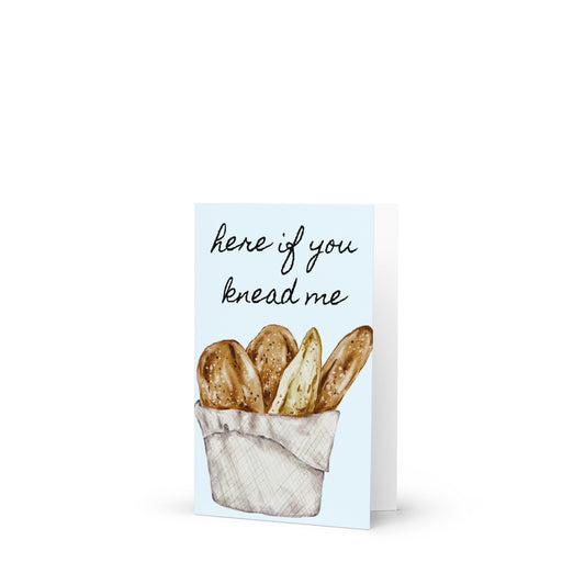 Greeting card with bread illustration and text 'here if you knead me' on a white background