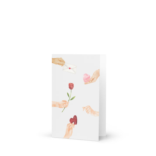 Greeting card with illustrations of hands holding a rose and a heart on a white background