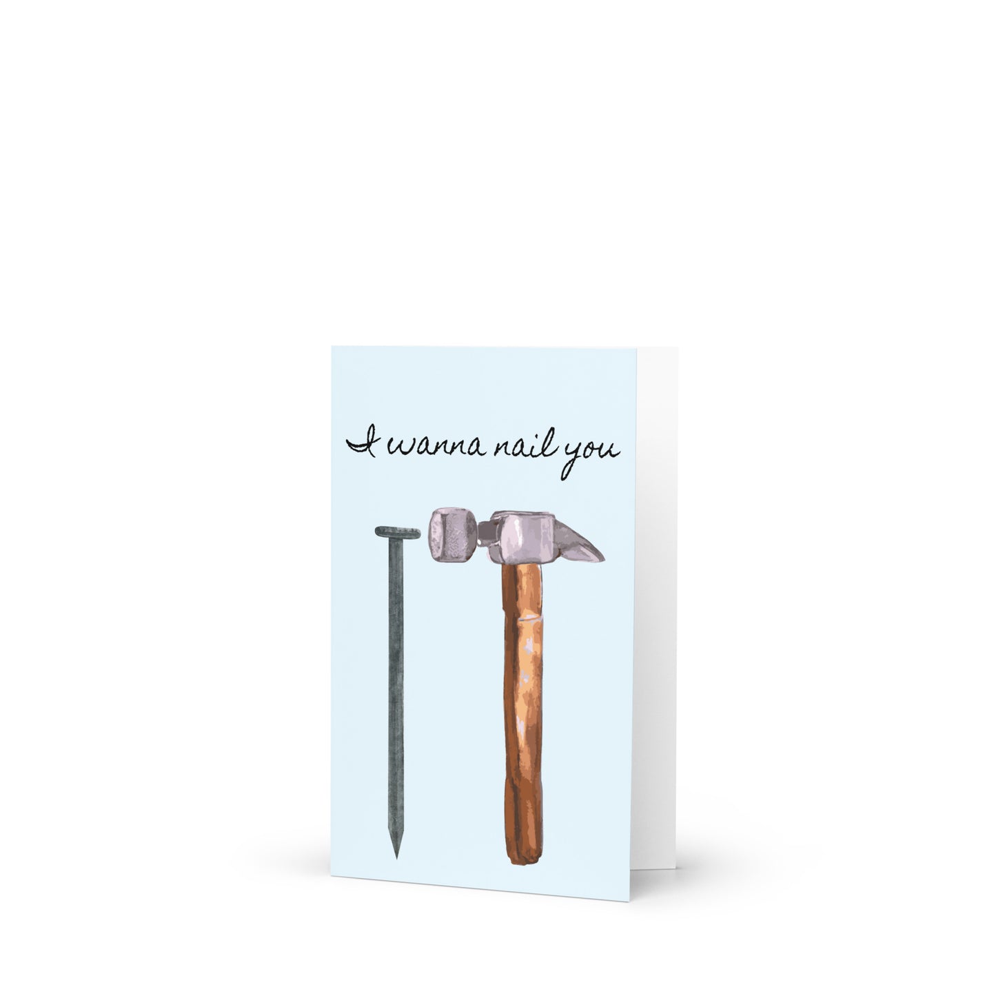 Greeting card with a hammer and nail illustration and text 'I wanna nail you' on a light blue background.