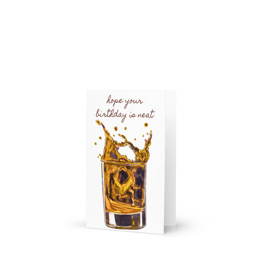 Greeting card with a shot glass of whiskey and text 'hope your birthday is neat' on a white background