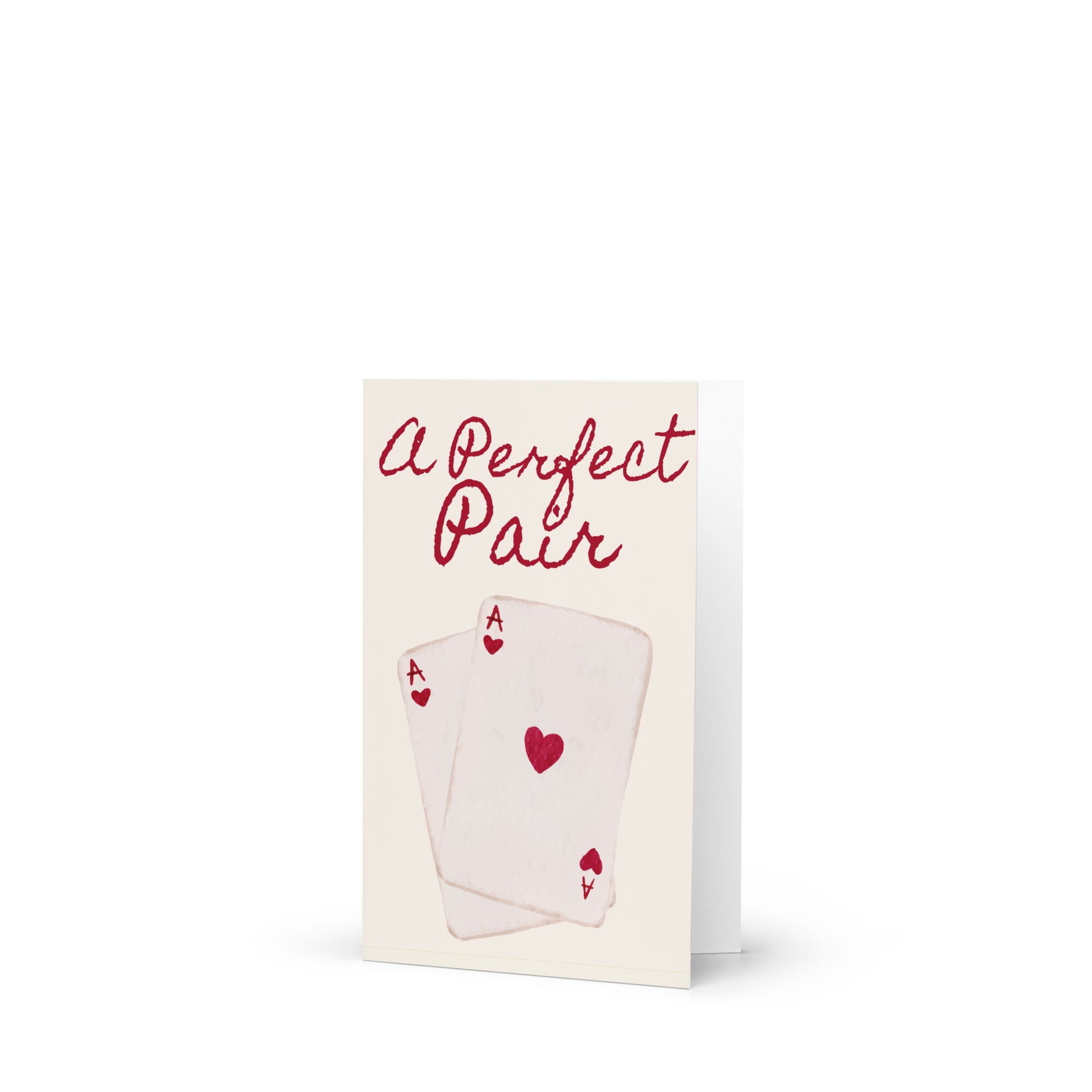 Greeting card with playing cards and 'A Perfect Pair' text on a white background
