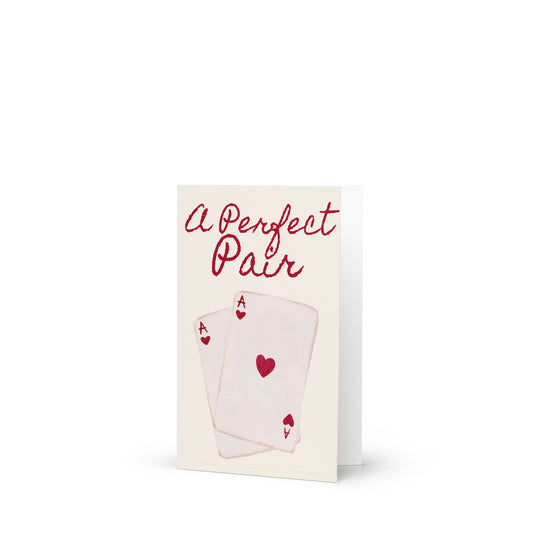 Greeting card with playing cards and 'A Perfect Pair' text on a white background
