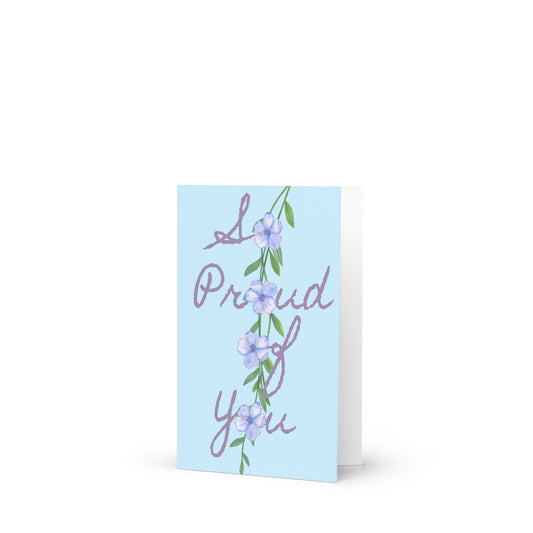Greeting card with 'I'm Proud of You' text and floral design on a light blue background