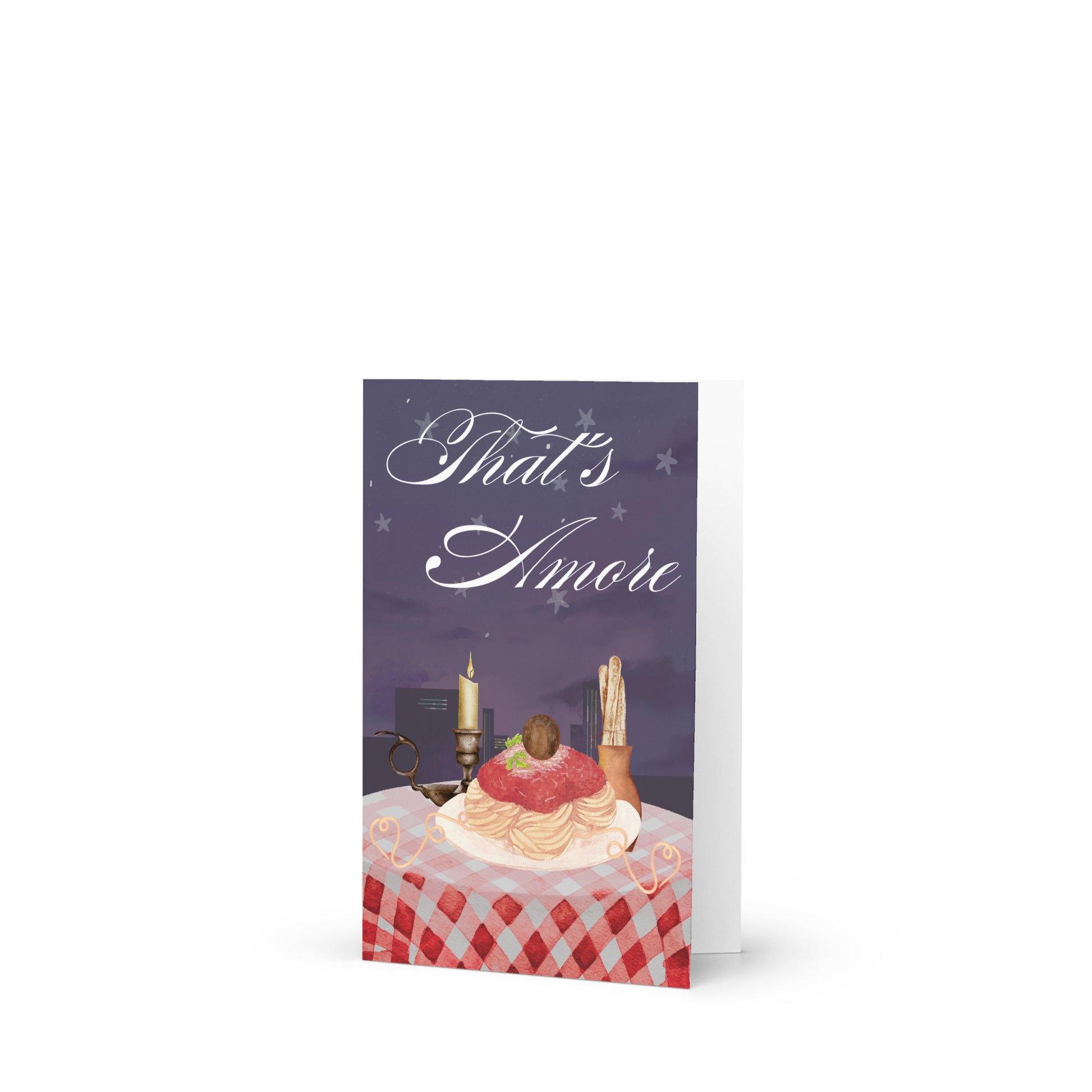 Greeting card with a romantic scene of a cake and candles on a checkered tablecloth, featuring the text 'That's Amore'.