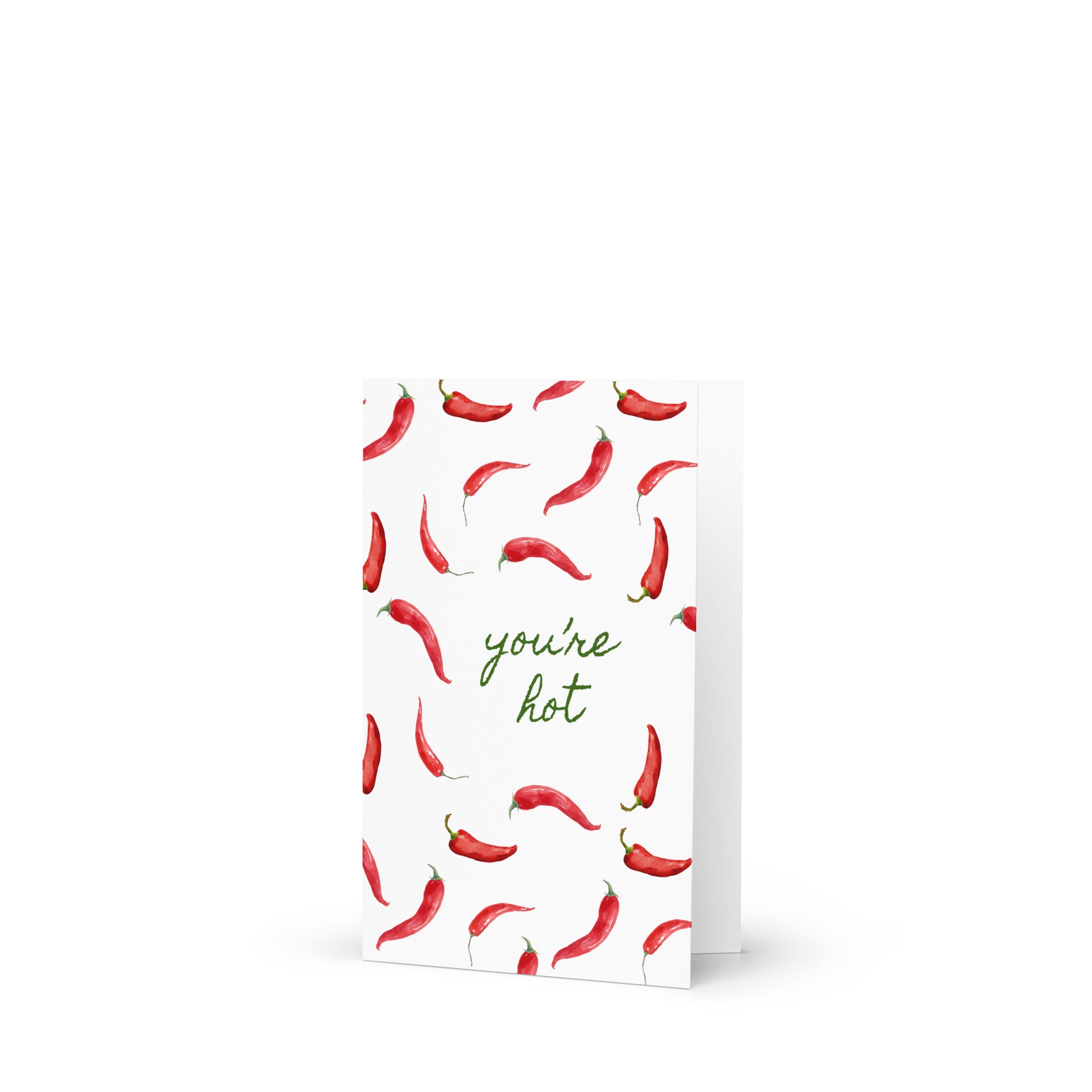 Greeting card with red chili pepper pattern and 'you're hot' text on a white background