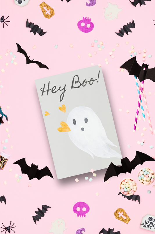 Halloween-themed notepad with ghost design and 'Hey Boo!' text on a pink background with Halloween decorations.