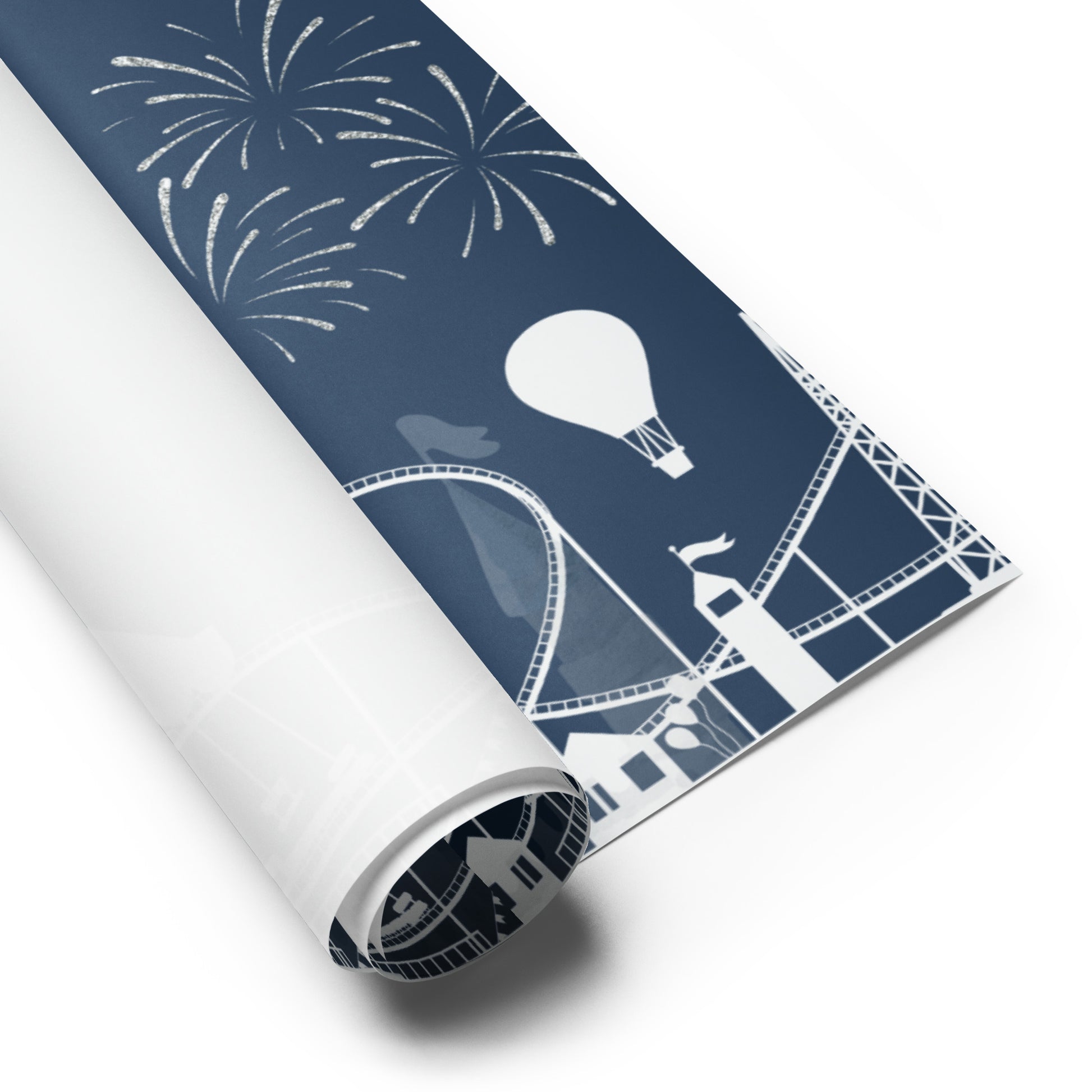 Roll of wrapping paper with a design of a hot air balloon, Ferris wheel, and fireworks on a blue background.