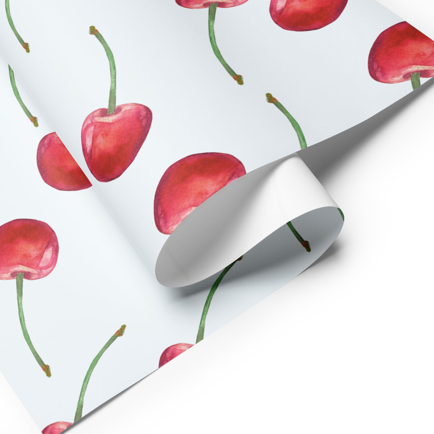 Roll of paper with red cherry pattern on a white background