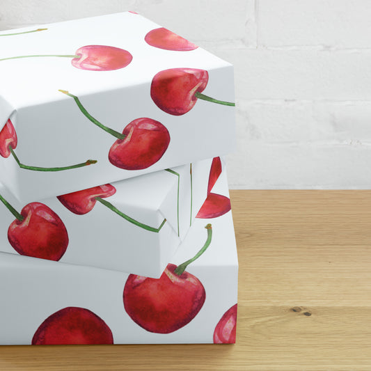 Gift box with cherry pattern on a wooden surface