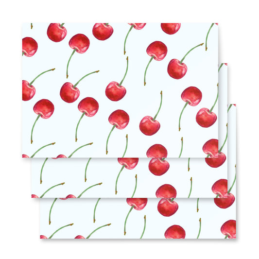 Cherry-patterned paper with red cherries on a white background