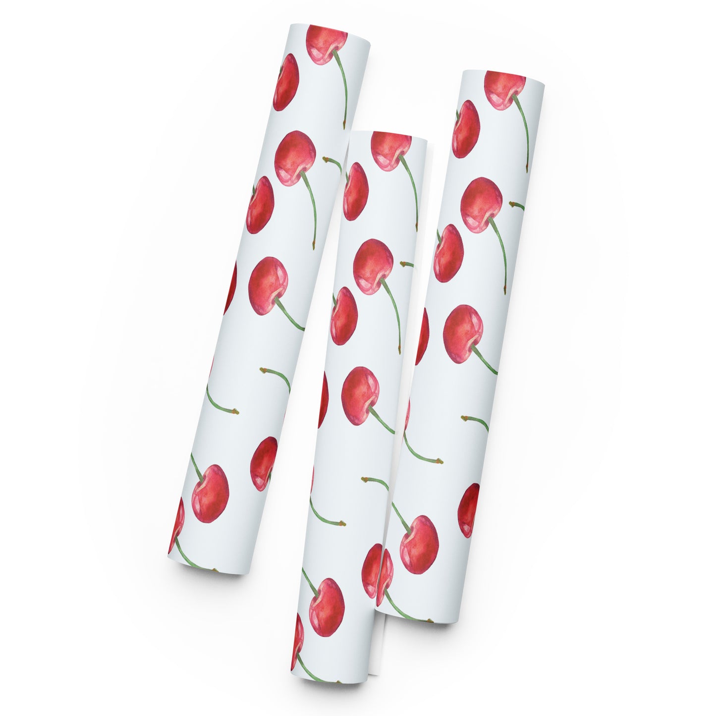 Three rolls of paper with red cherry pattern on a white background