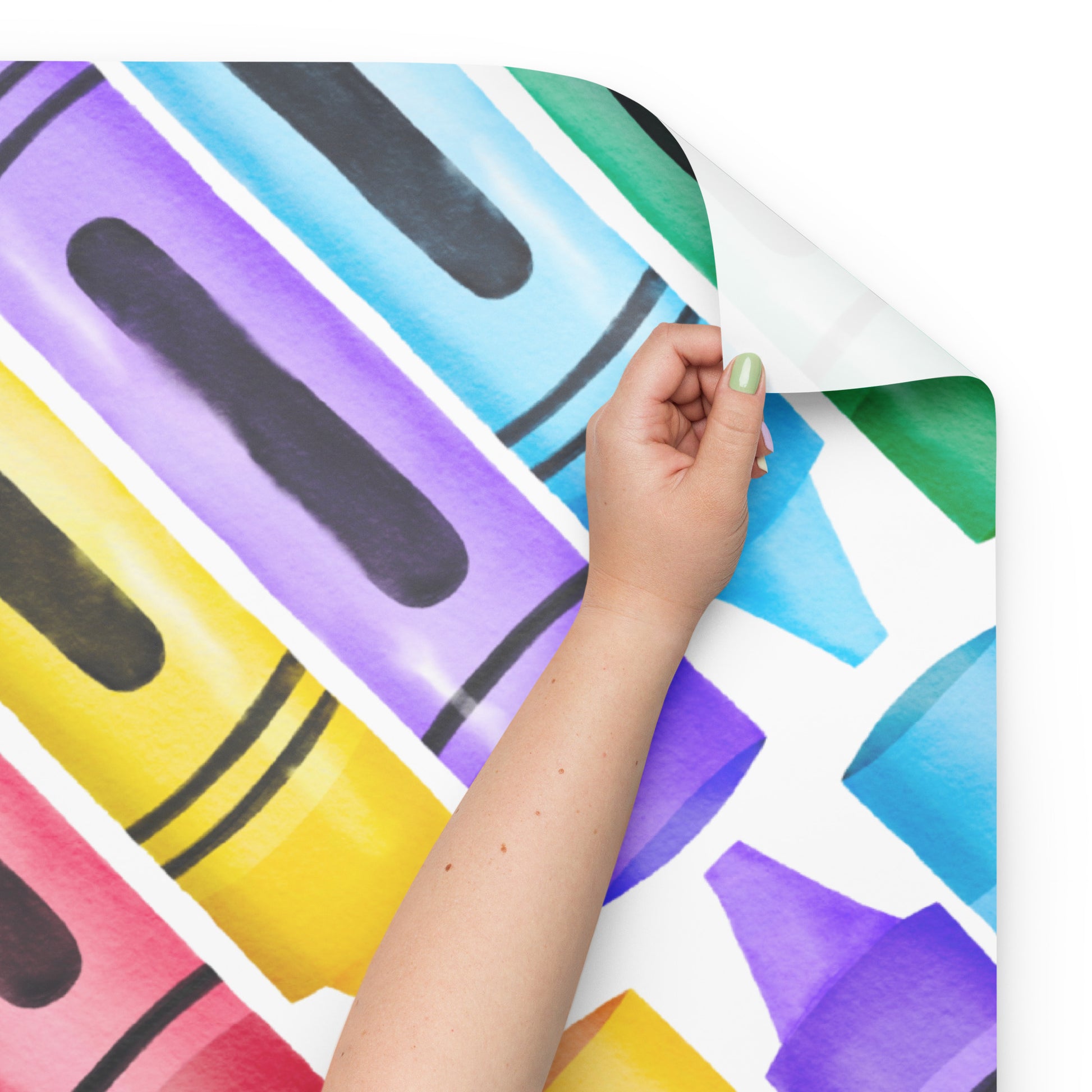 Colorful patterned paper with a hand holding it against a white background