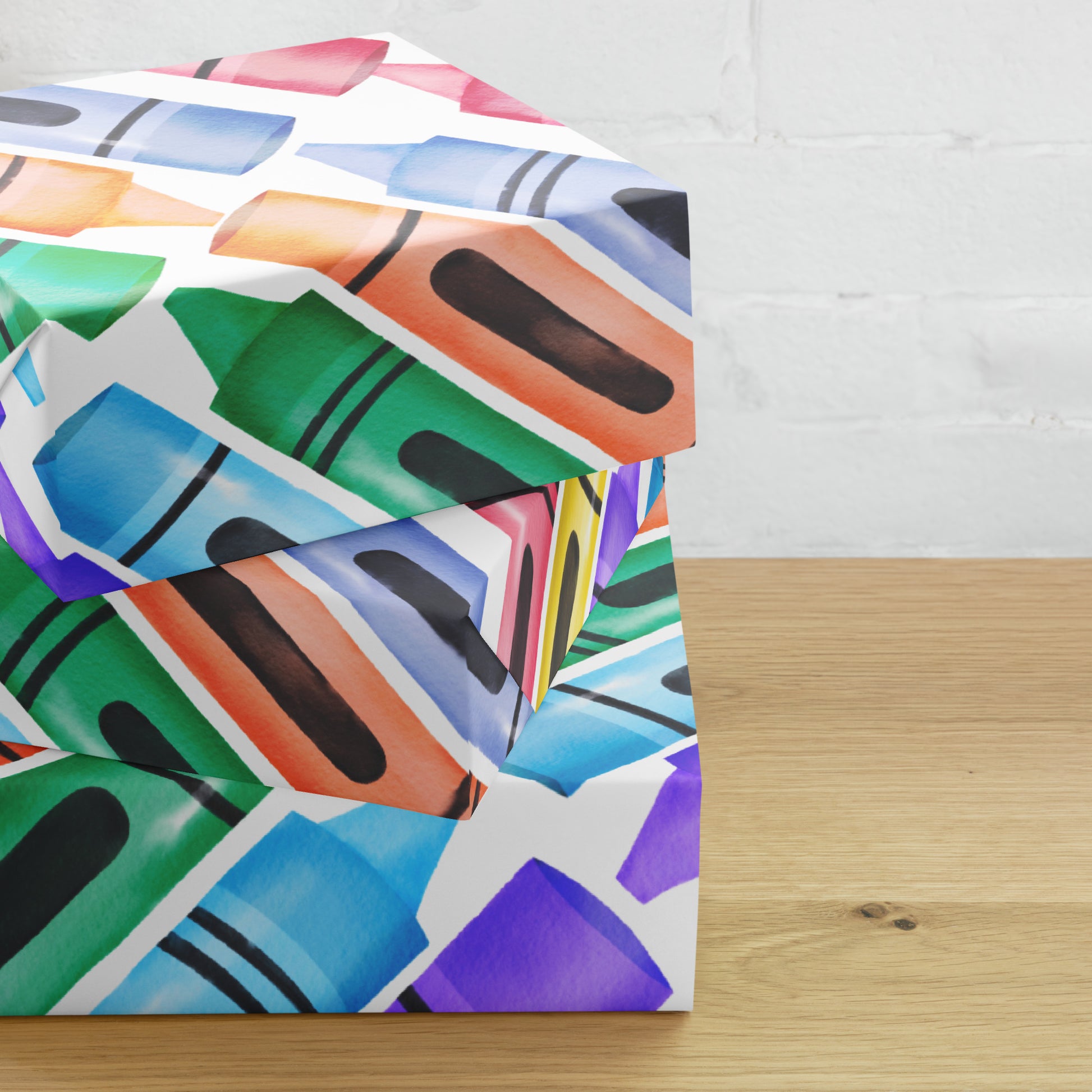 Colorful crayon patterned paper on a wooden surface with a white brick wall background