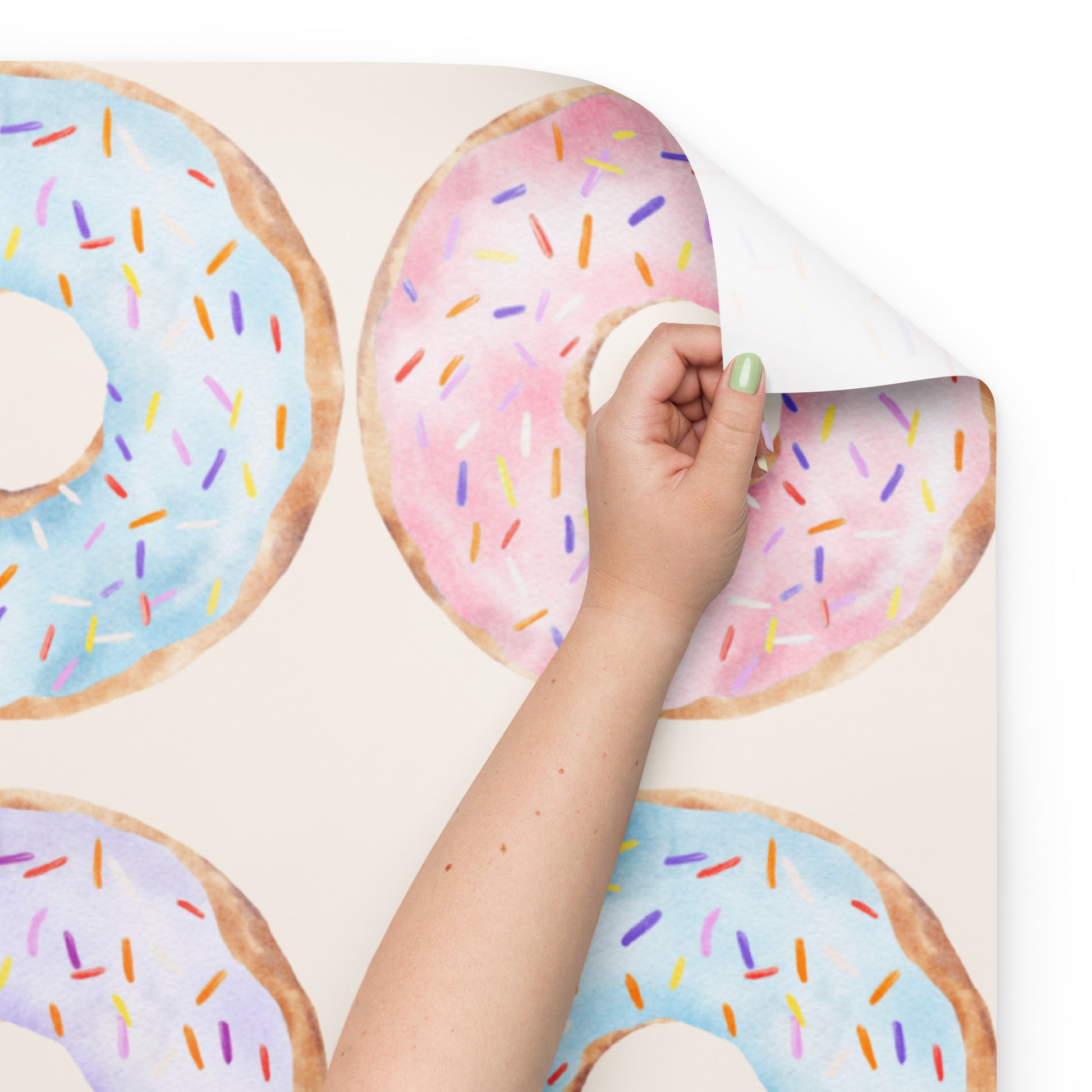 Colorful donut-shaped cookies with sprinkles on a white background