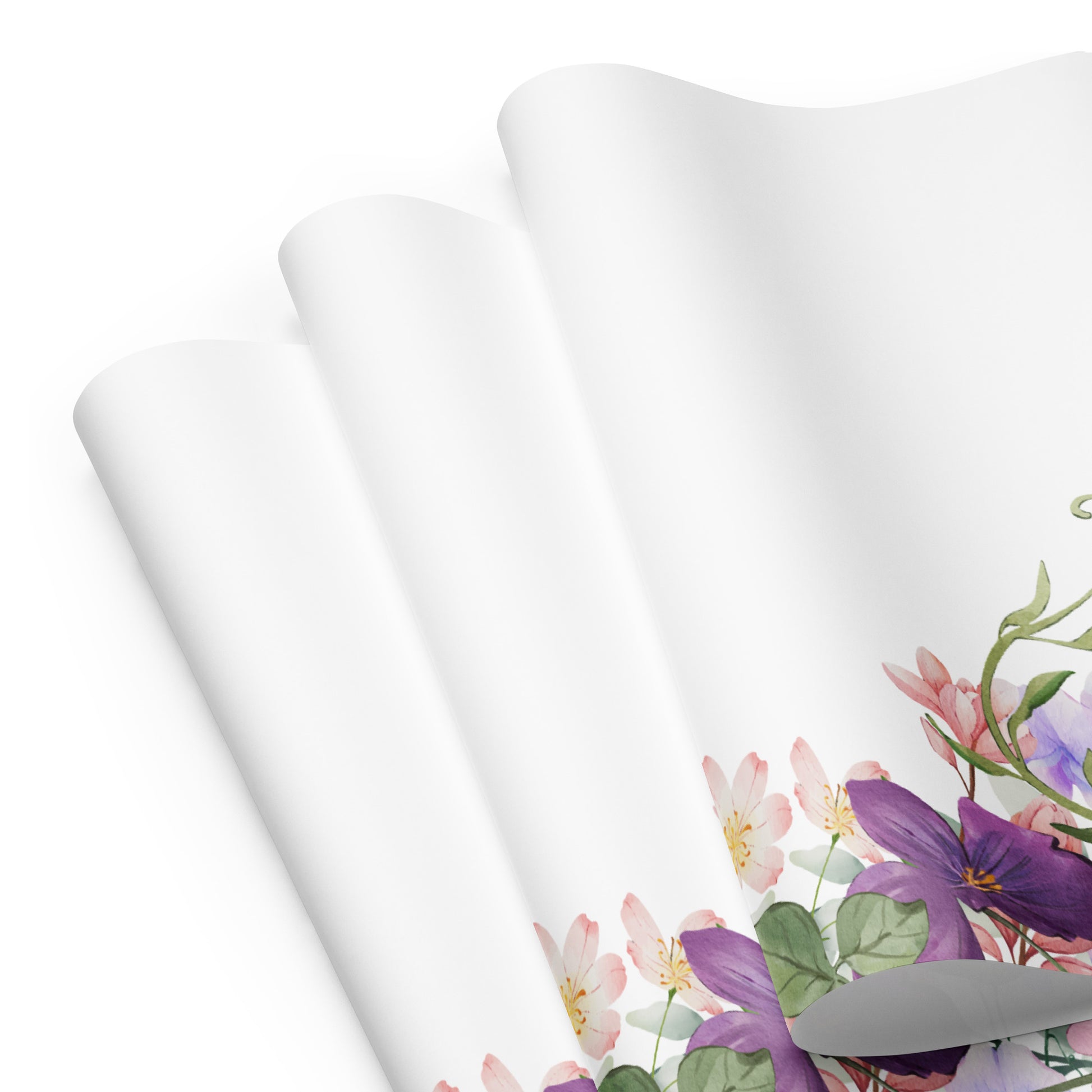 Floral-patterned fabric with purple and green flowers on a white background