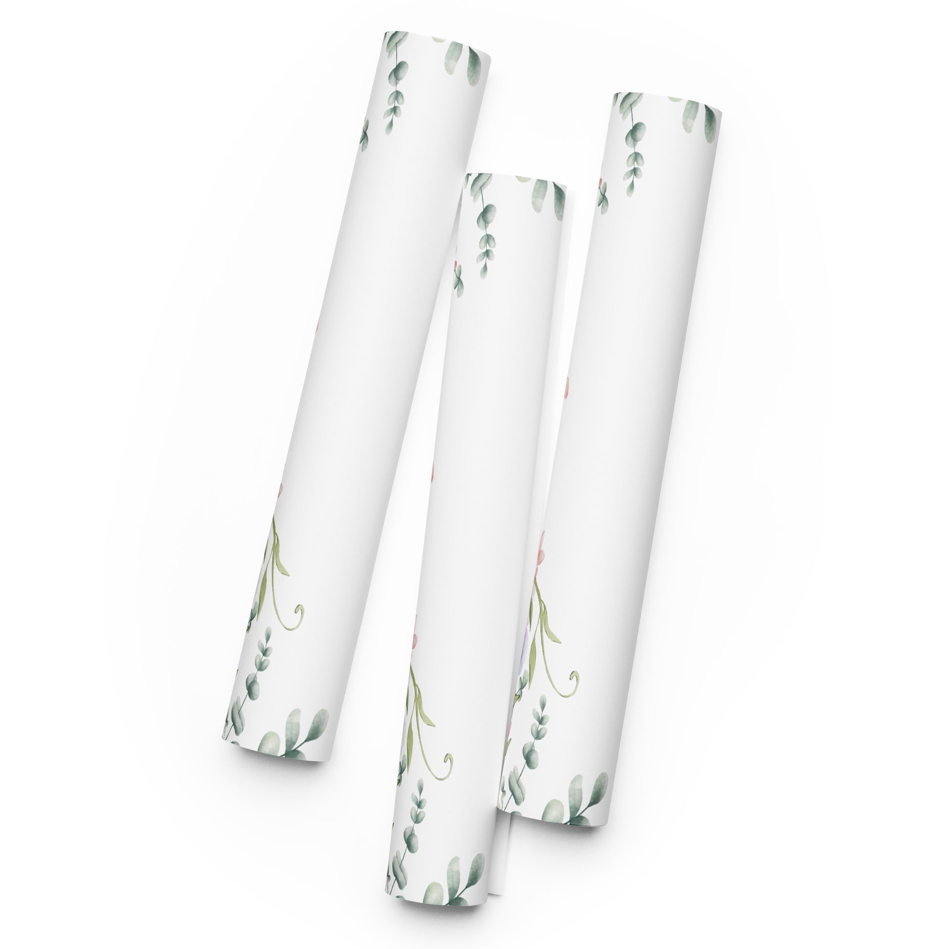 Three cylindrical paper rolls with floral patterns on a white background