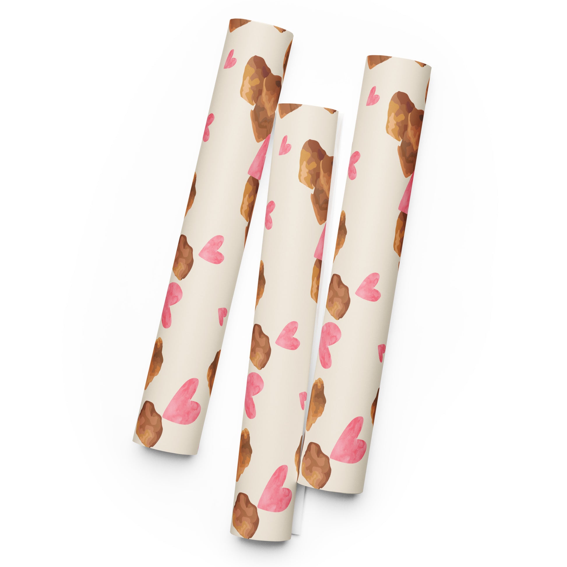 Three cylindrical tubes with a pattern of brown nuggets and pink hearts on a white background