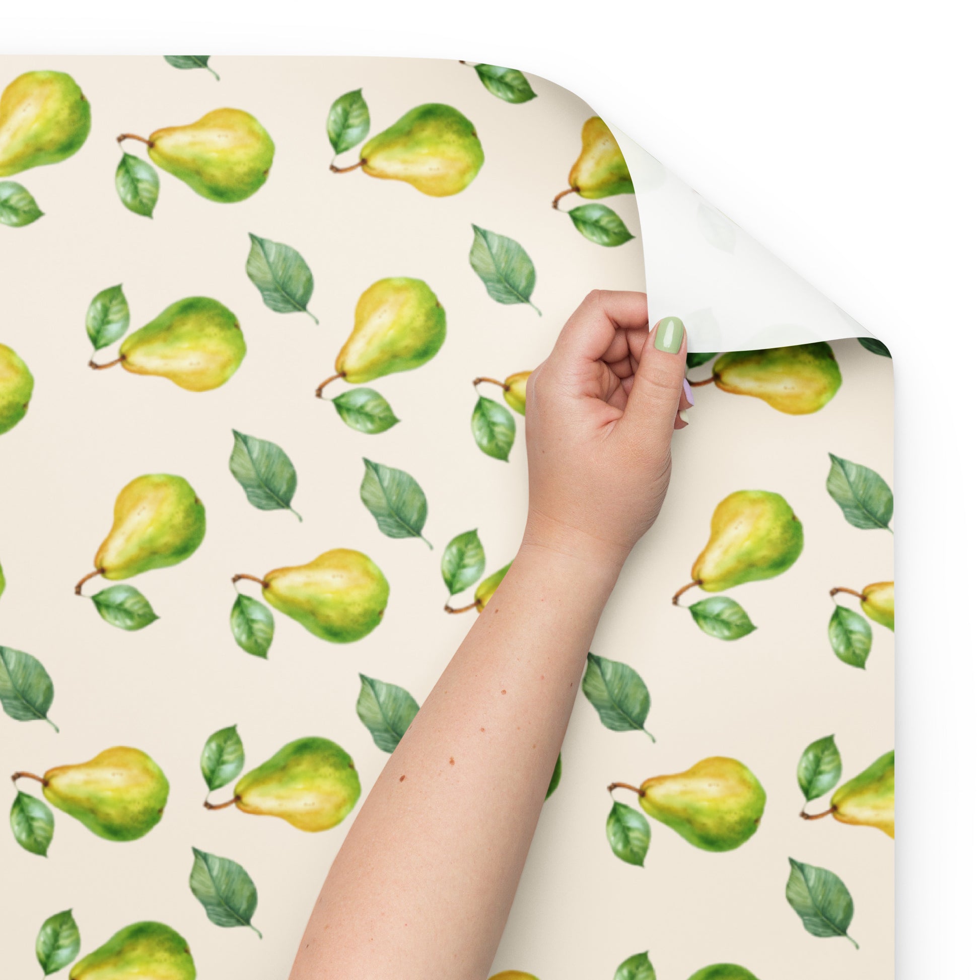 Hand holding a sheet of paper with green pear pattern