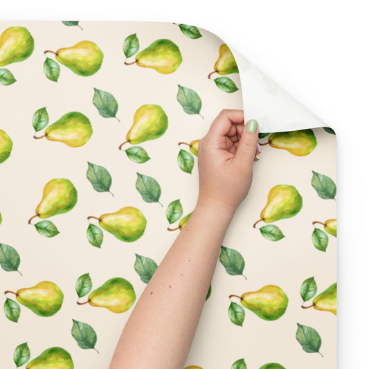 Hand holding a sheet of paper with green pear pattern