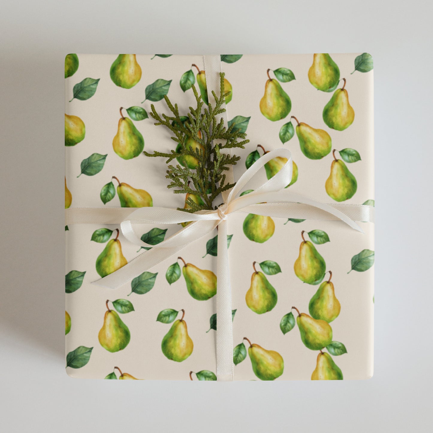 Gift wrapped in paper with green pear pattern on a white background