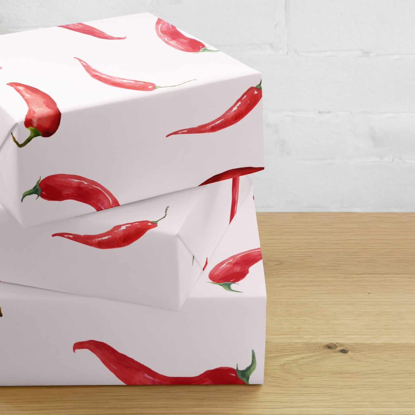 White box with red chili pepper pattern on a wooden surface
