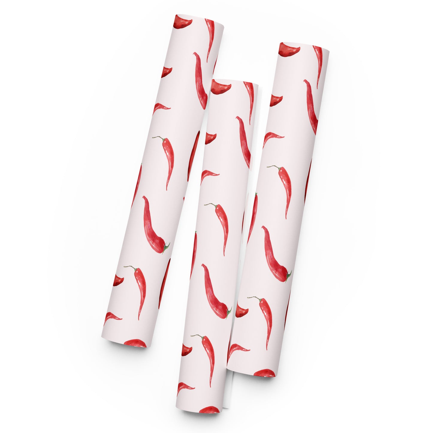Three rolls of paper with red chili pepper pattern on a white background