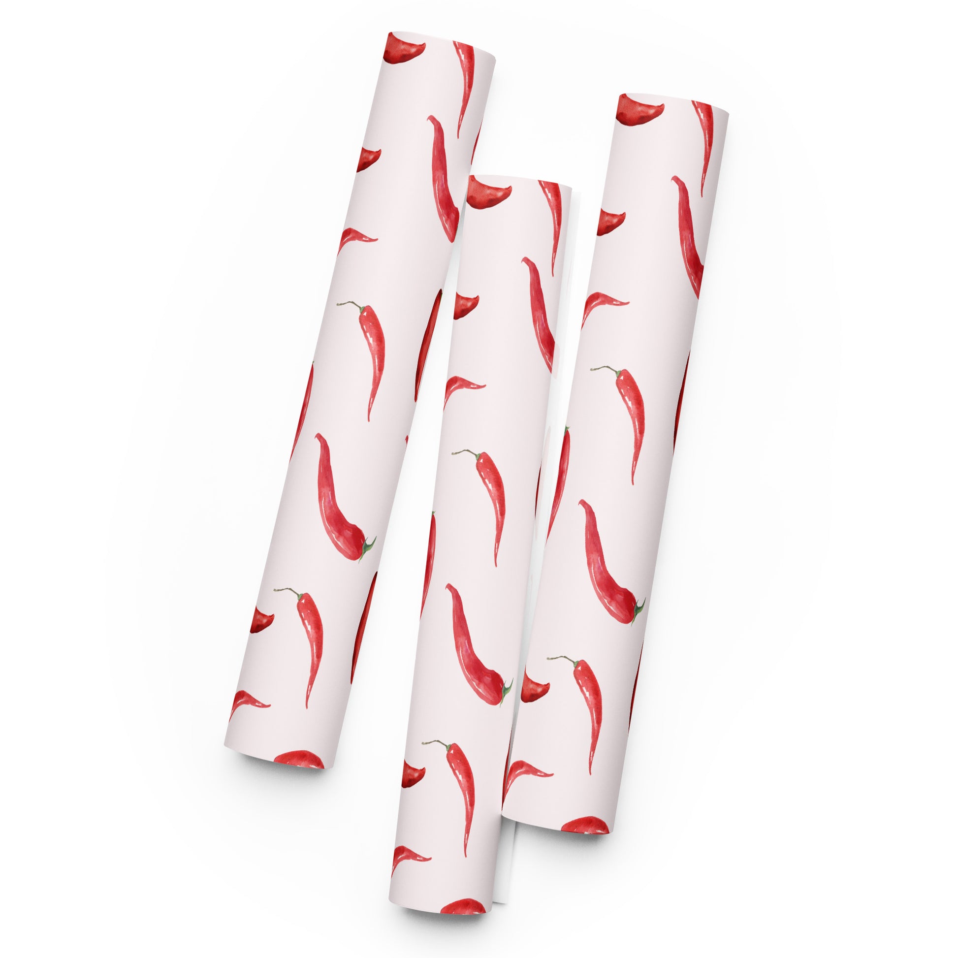 Three rolls of paper with red chili pepper pattern on a white background