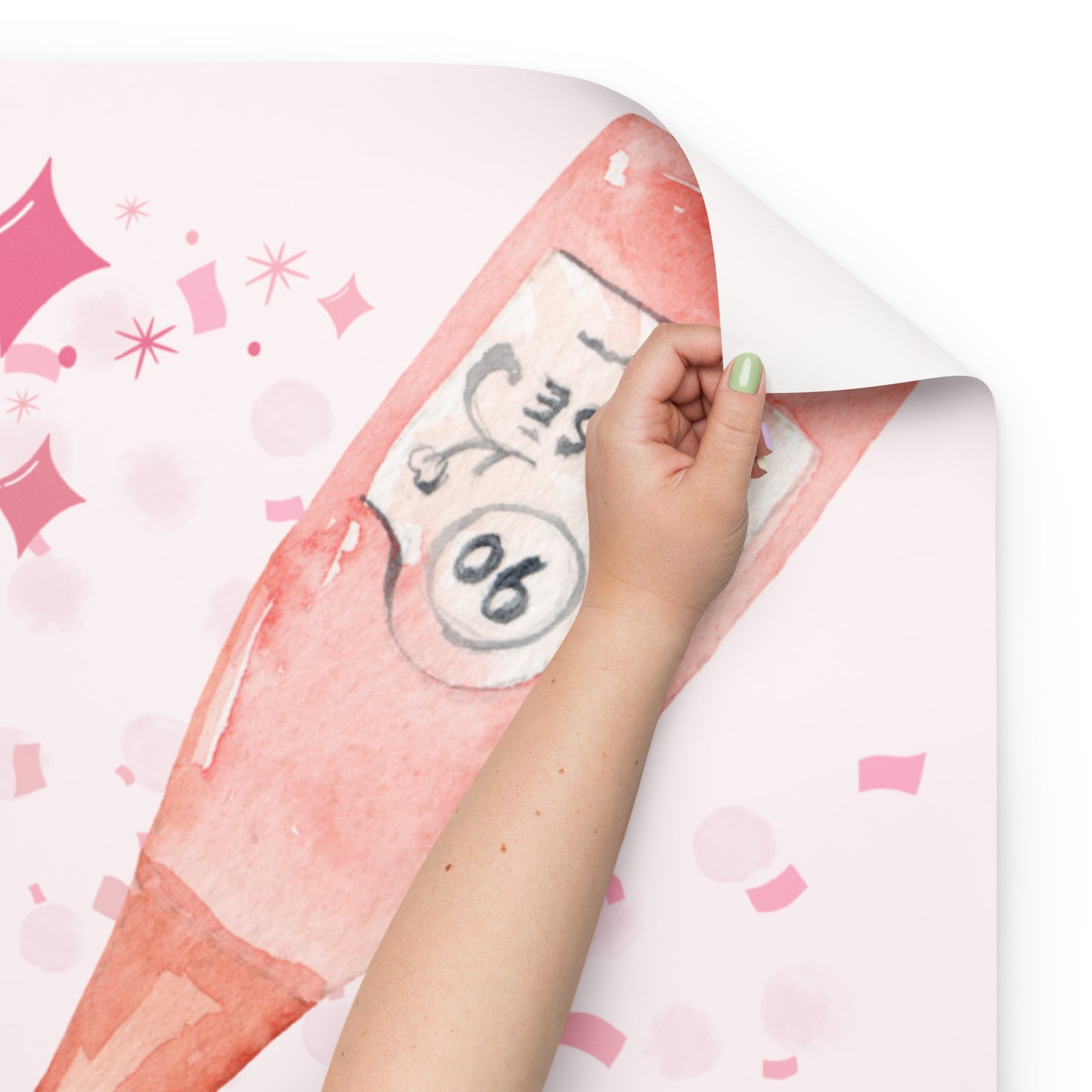 Hand peeling back a pink and white sticker with decorative elements on a white background